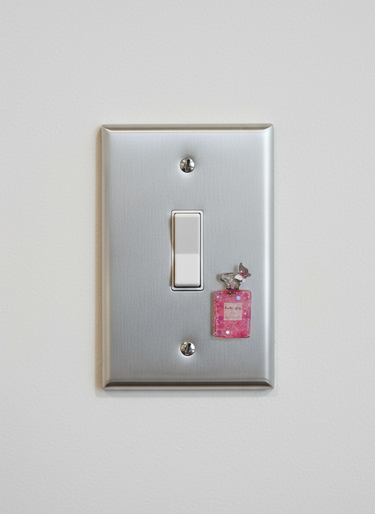 Light switch cover pink perfume bottle embellishment