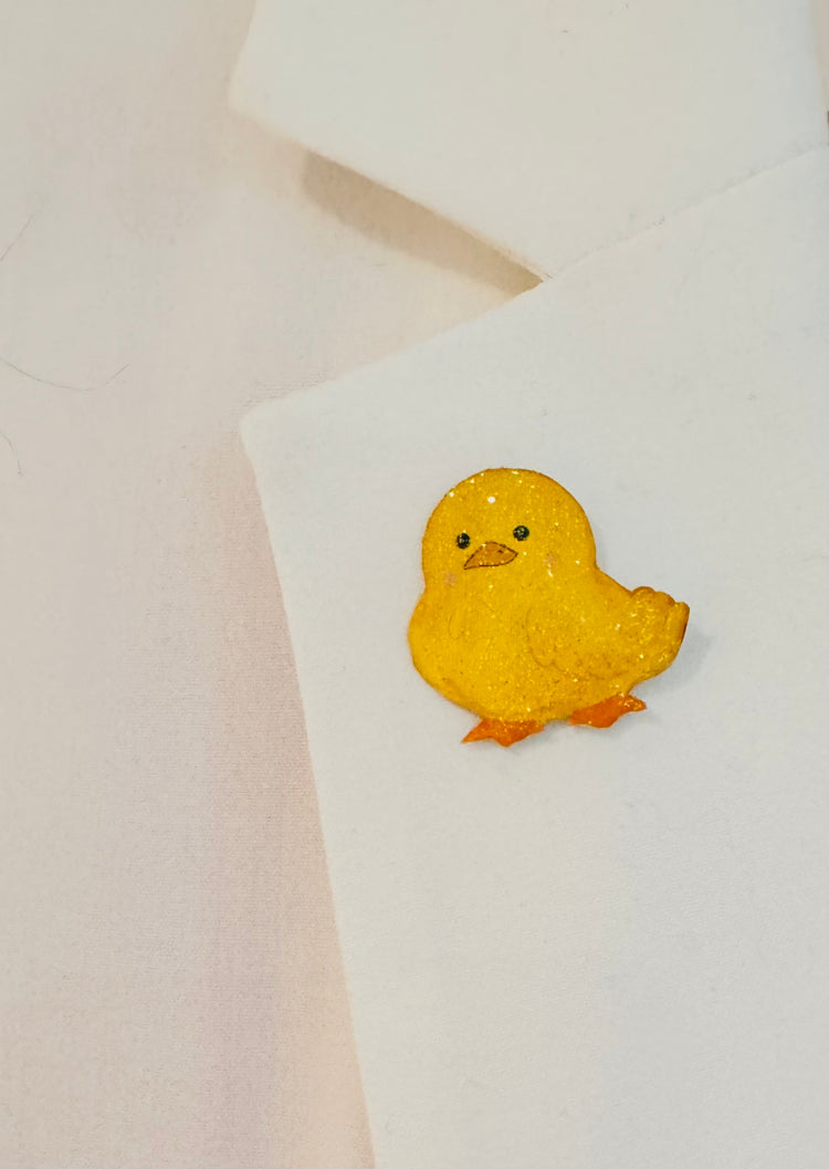 Ducks in a row enamel pins.