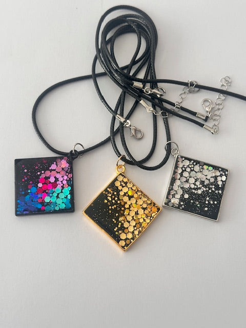 hand crafted resin pendant on a black cord