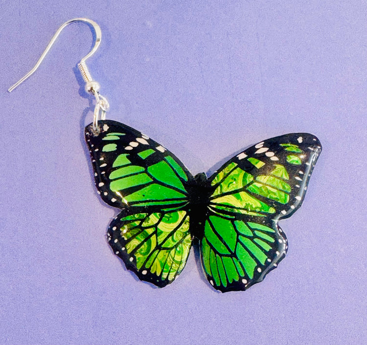 green butterfly earrings made from soda cans