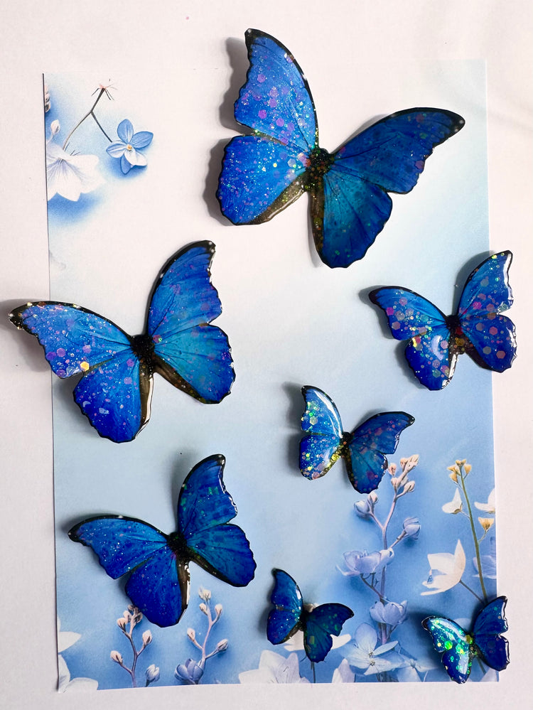 Blue butterfly decorations on a light blue background with white flowers.