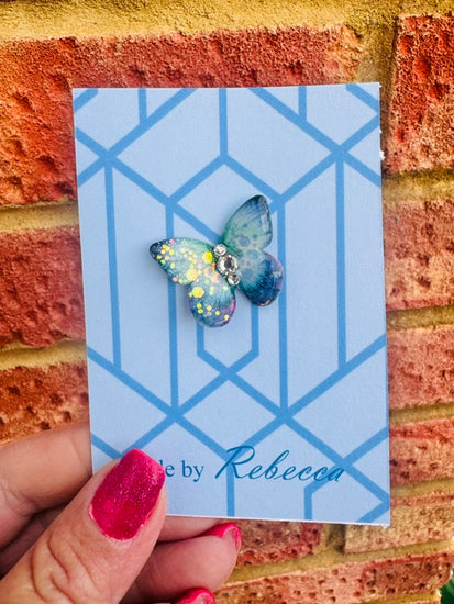 Handmade Blue butterfly enamel pin.