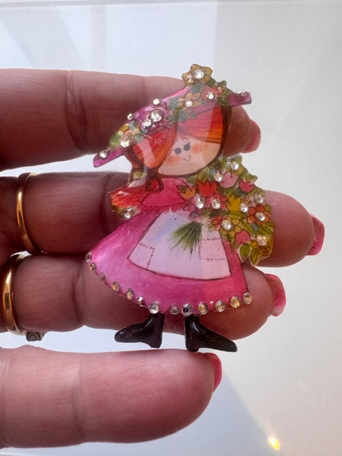 very pretty vintage inspired brooch features a sweet old lady holding flowers