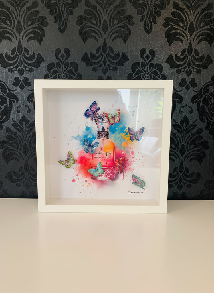 Framed artwork of a colorful perfume bottle with butterflies , tin can art