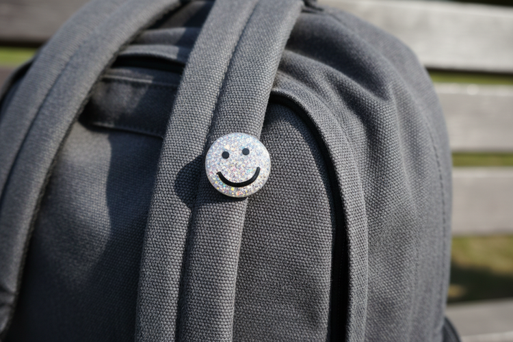 silver glittery smiley face button