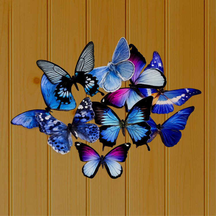 A cluster of blue butterfly wall art pieces in shades of blue