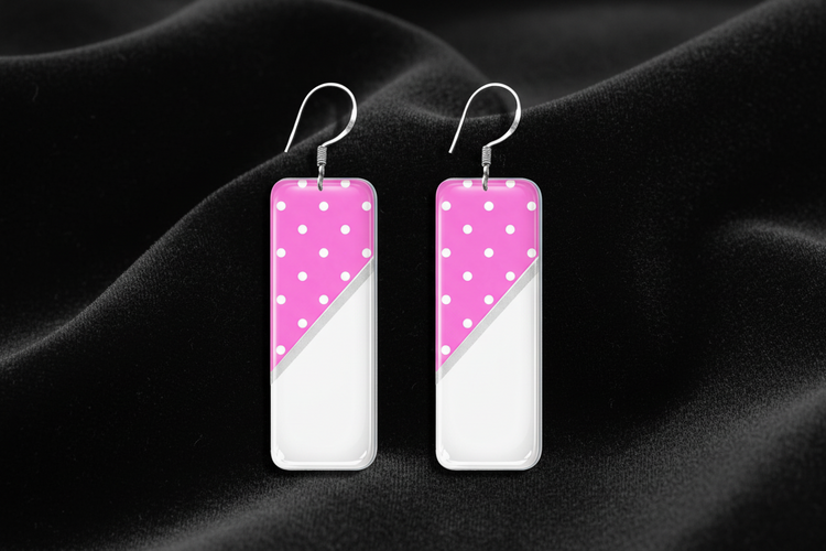 Pair of earrings with pink and white polka dot design