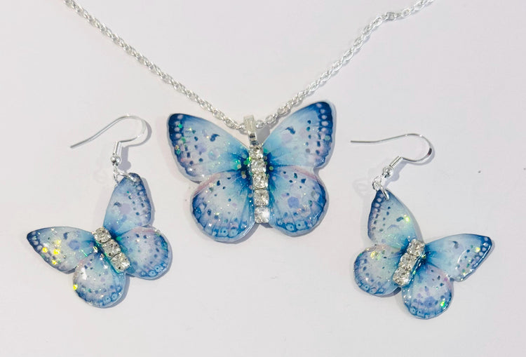 Very pretty blue with a touch of pink butterfly earrings and pendant set