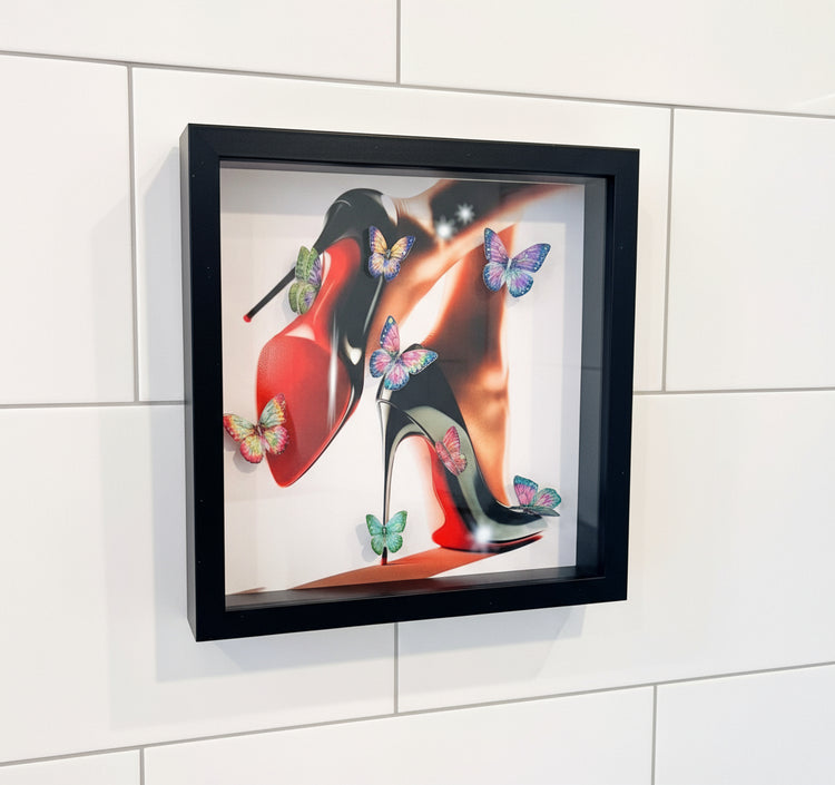 Framed artwork of high-heeled shoes with butterflies