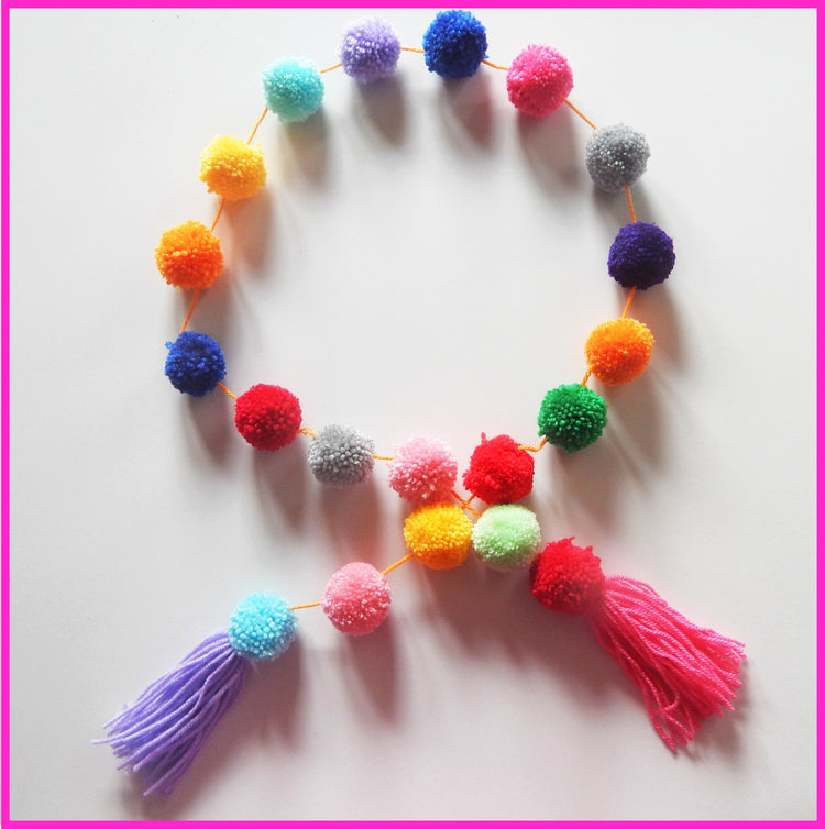 pom pom rainbow garland for outside party decor