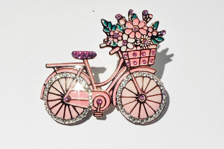 Pink bicycle-shaped brooch with a basket of flowers