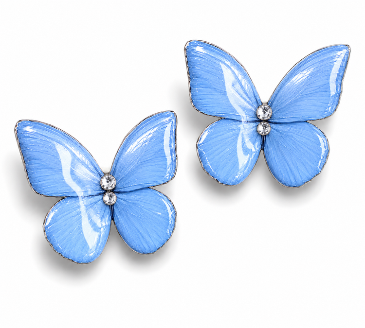 A pair of light blue butterfly-shaped earrings with silver-tone edges and small clear rhinestone 