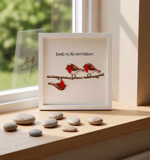 Framed artwork with birds on a branch and 'Dare to be different'