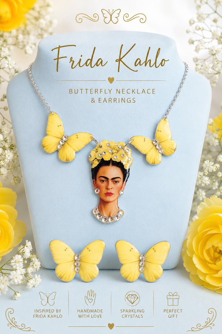 A jewelry set displayed on a light blue stand, featuring a butterfly necklace and matching earrings with bright yellow butterfly charms and clear rhinestone accents. The stand is printed with a portrait of Frida Kahlo and the text 'Frida Kahlo Butterfly Necklace & Earrings,' surrounded by yellow roses and white flowers.