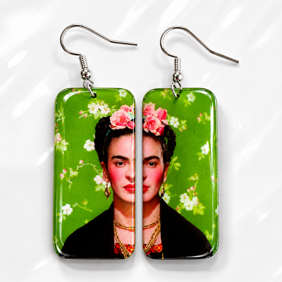 Frida Kahlo earrings with floral design on a green background