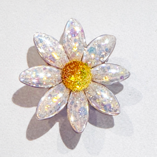 Sparkly daisy flower brooch with a yellow centre 