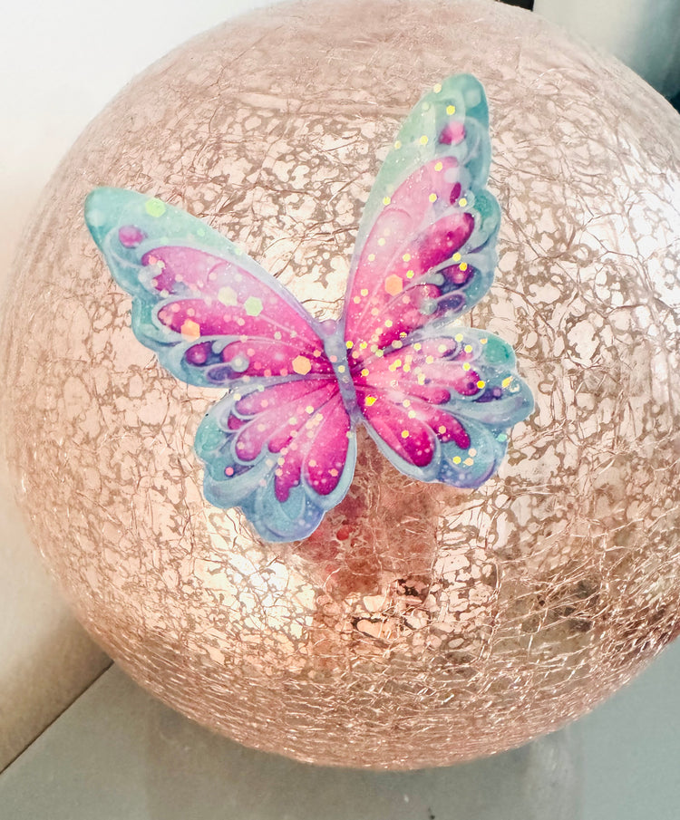 Decorative sphere with a colorful butterfly on a light background