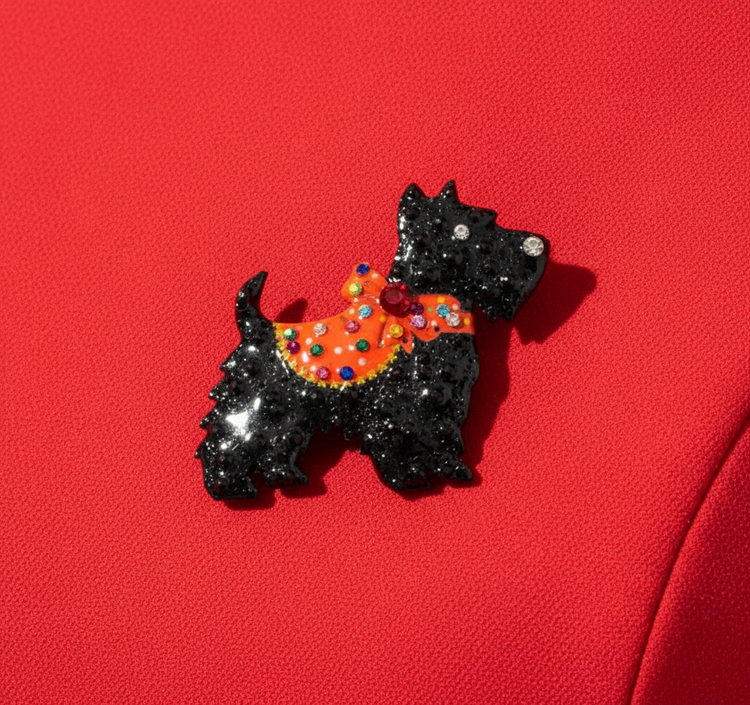Black scottie dog-shaped brooch with a colourful bow 