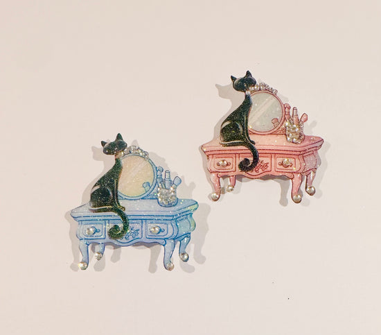 retro black cat on a pink or blue dressing table black cat
