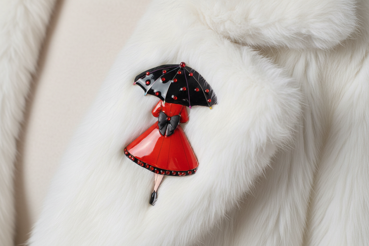 beautiful retro handmade brooch of a lady in red with black umbrella