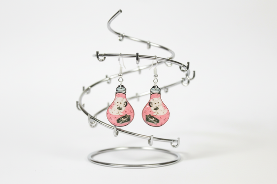 Pink earrings with a light bulb design 