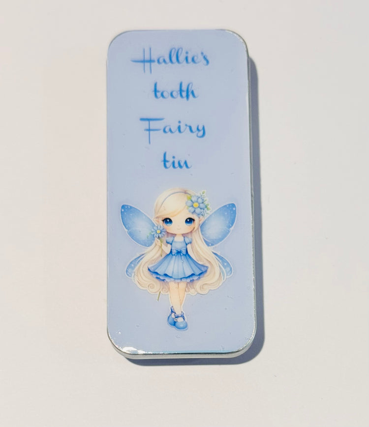 Tooth fairy tin with a fairy illustration on a light blue background tin