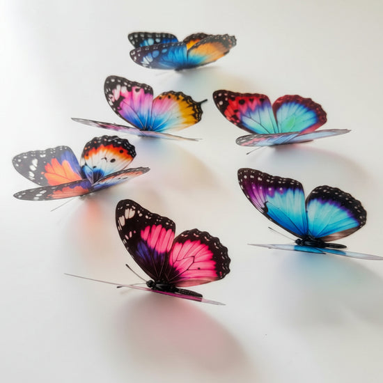 Six colorful artificial butterfly wall decorations with vibrant blue, pink, orange, and purple wing