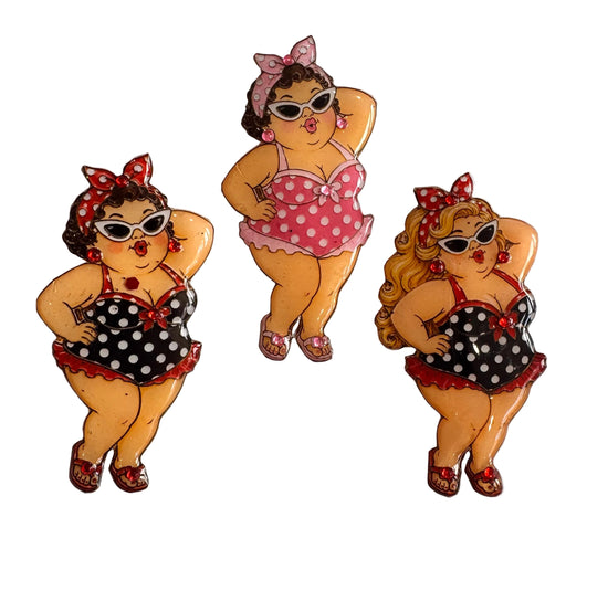 Three vintage-style brooches of women in polka dot swimsuits brooches