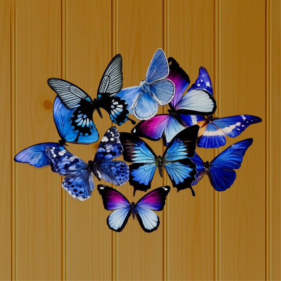 A cluster of blue butterfly wall art pieces in shades of blue