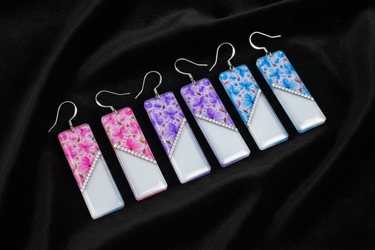 Floral long drop earrings. Handmade jewellery by Flutterframes. In lilac, pink and blue