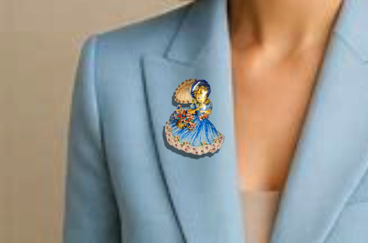Decorative brooch with a girl in a blue dress holding an umbrella made from recycled  tin cans