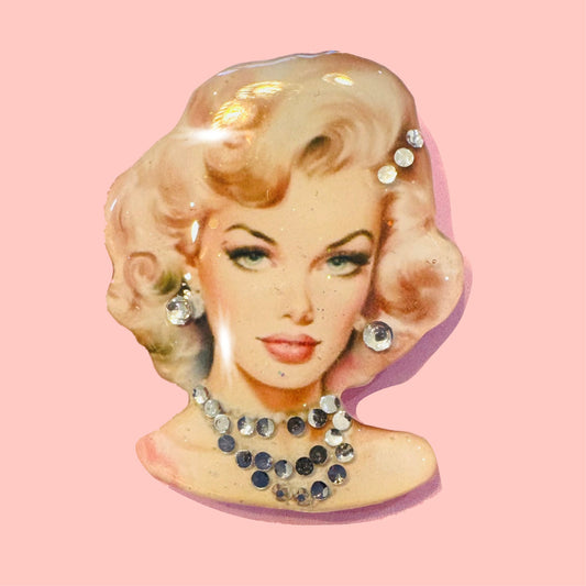 Vintage-style brooch with a woman's face and diamantes